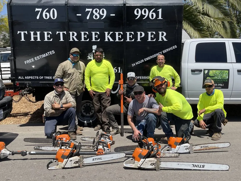 The Tree Keeper crew with their chainsaws in front of the company truck